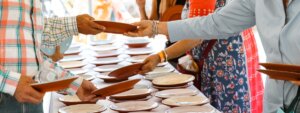 People in line select ceramic plates