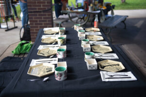 handmade ceramic place settings on black tablecloth