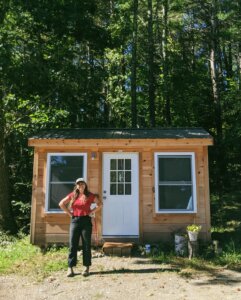 A cabin with a person standing in front