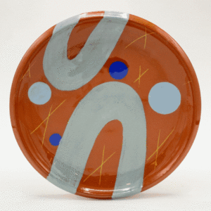A slideshow of images or plates made by Emily Armstrong. All made from terracotta with bold, colorful, and organic shapes.